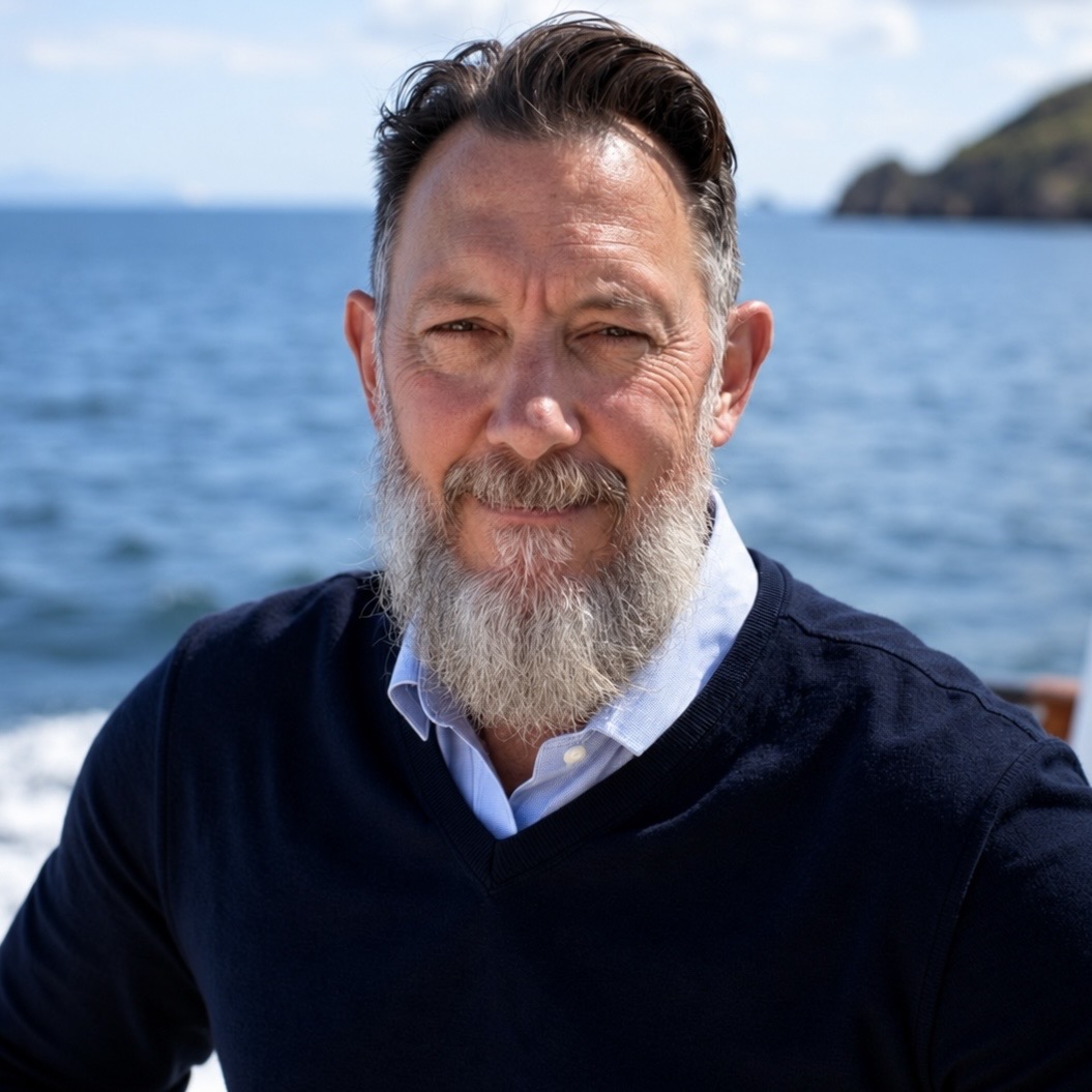 Dean Palmiere outdoors beside the sea.